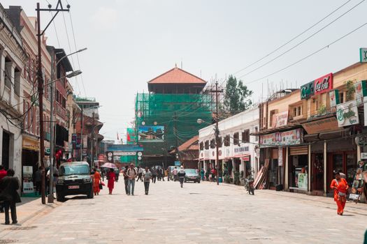 Vibrant street scene in Kathmandu featuring shops, tourists, and traditional architecture.