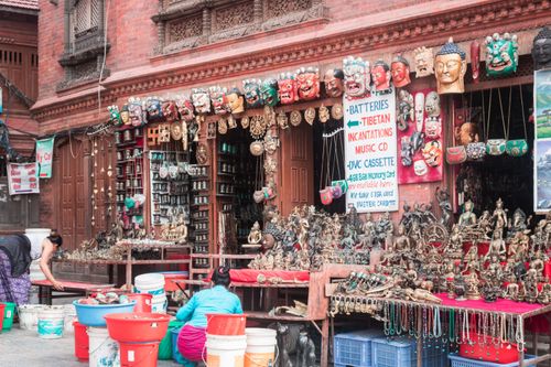 Free Colorful street market in Kathmandu with masks, statues, and crafts on display. Stock Photo