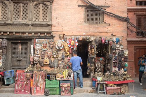 Free A vibrant street vendor stall in Kathmandu displaying colorful traditional masks and handicrafts. Stock Photo