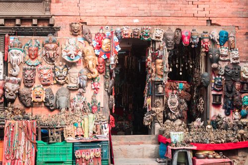 Free Vibrant display of traditional masks at a Kathmandu market, rich in cultural craftsmanship. Stock Photo