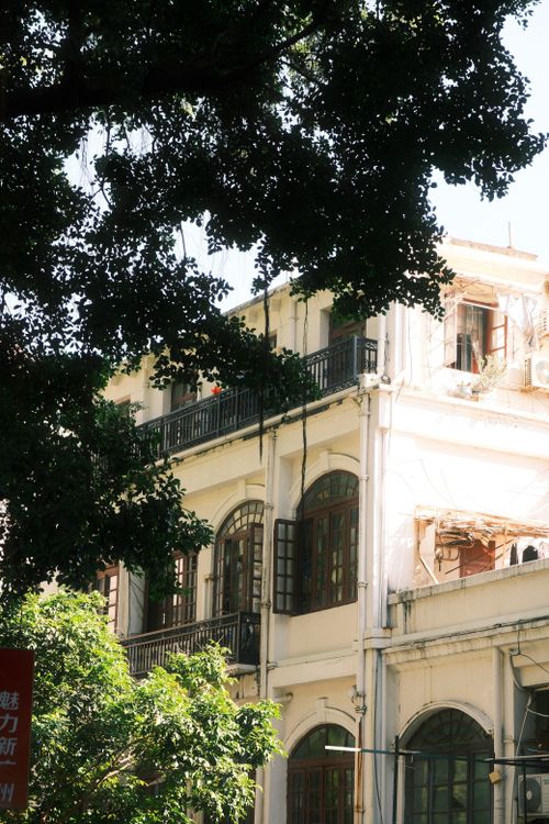 Free Charming colonial architecture amidst lush foliage in Guangzhou, capturing the essence of historic charm. Stock Photo