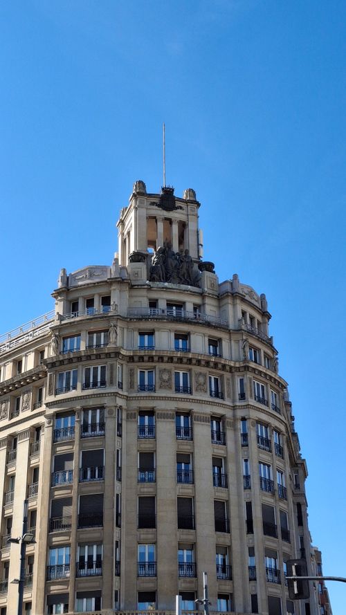 Free A classic historic building facade with detailed architecture under a vibrant blue sky. Stock Photo
