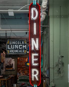 Vintage diner neon sign with retro style indoors, showcasing classic American decor.