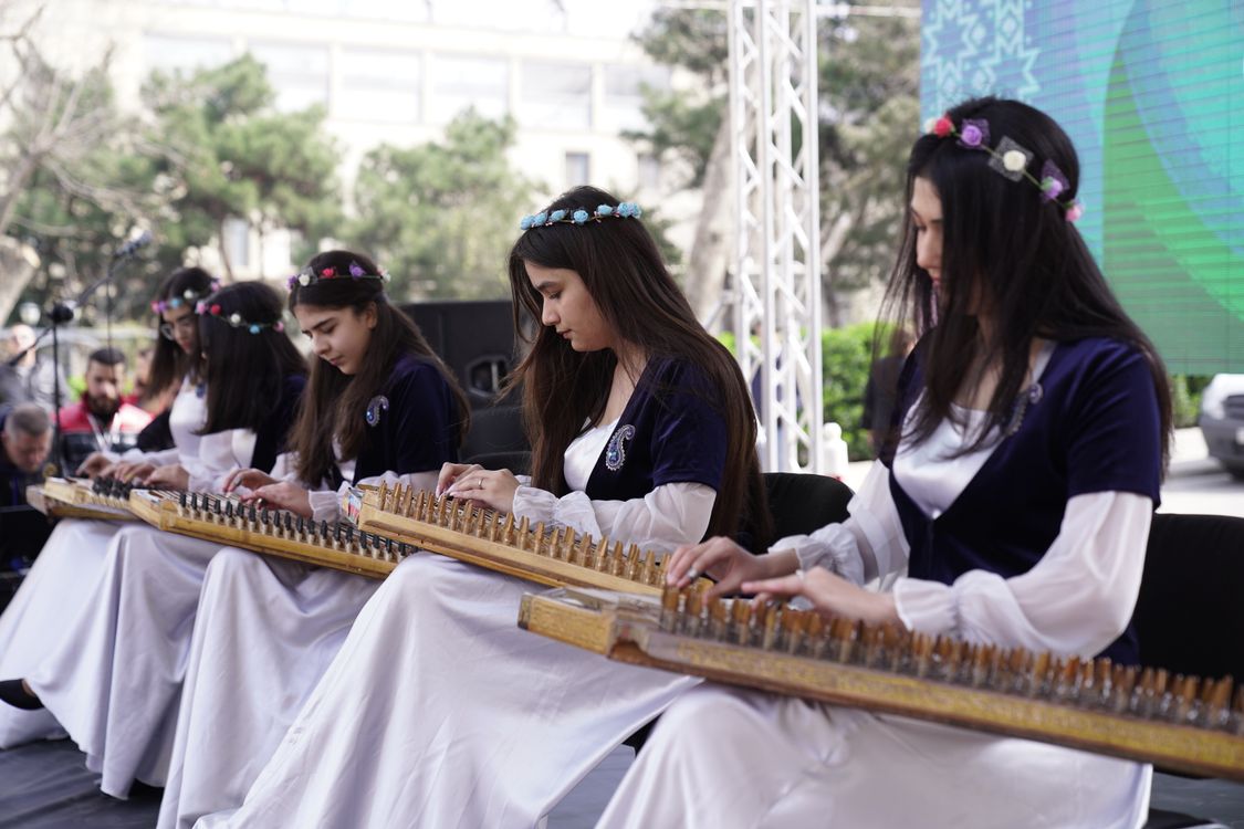 String Instruments Play Women Playing Traditional String Instruments Outdoors · Free Stock Photo