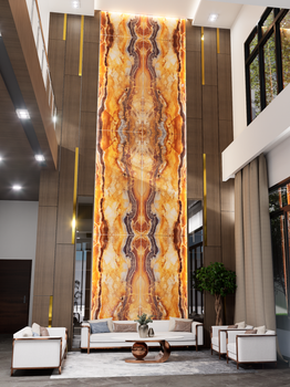 Stunning modern lobby with a towering marble wall, elegant seating, and natural lighting.