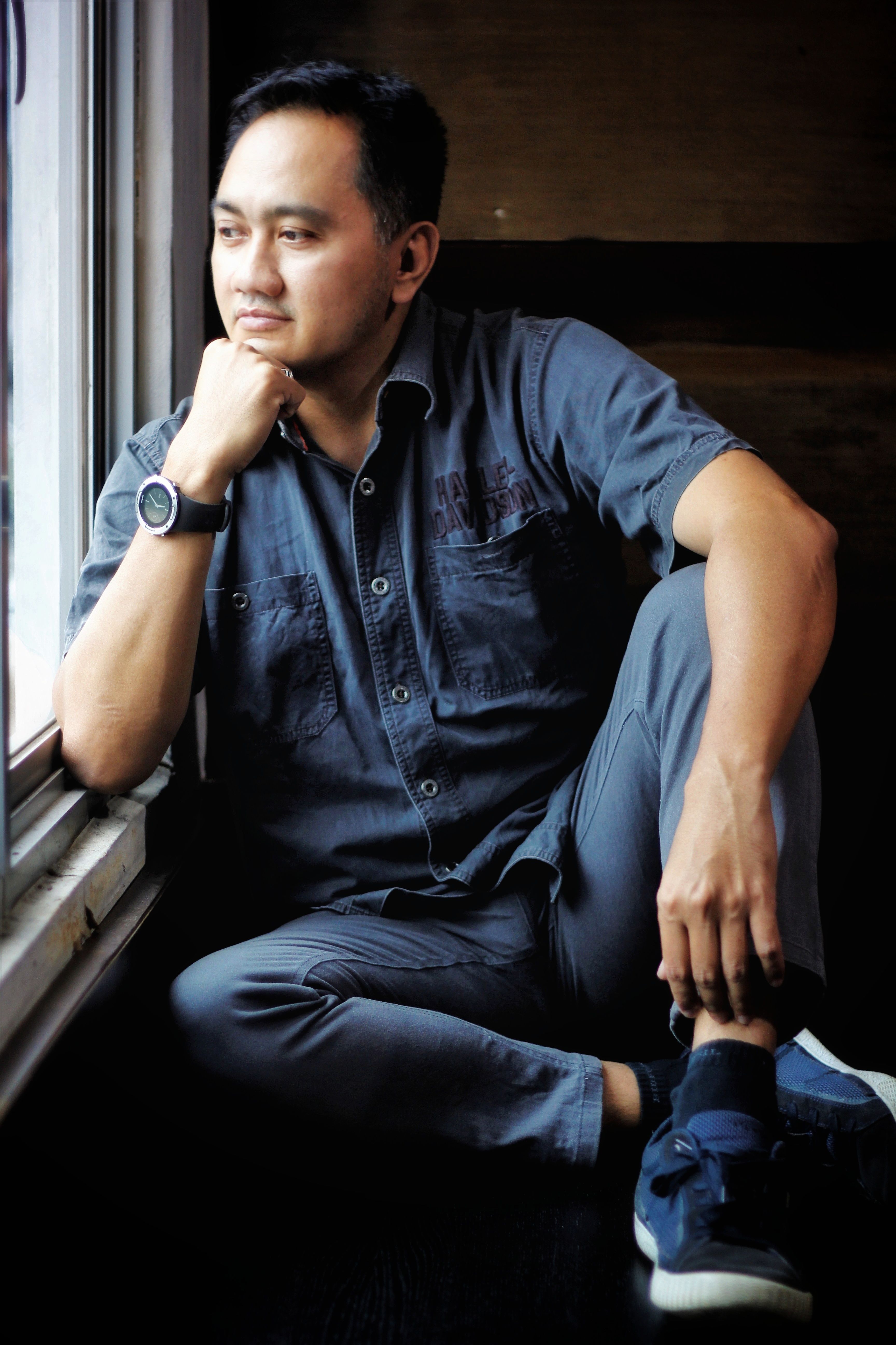 Contemplative Man Sitting by a Window Indoors