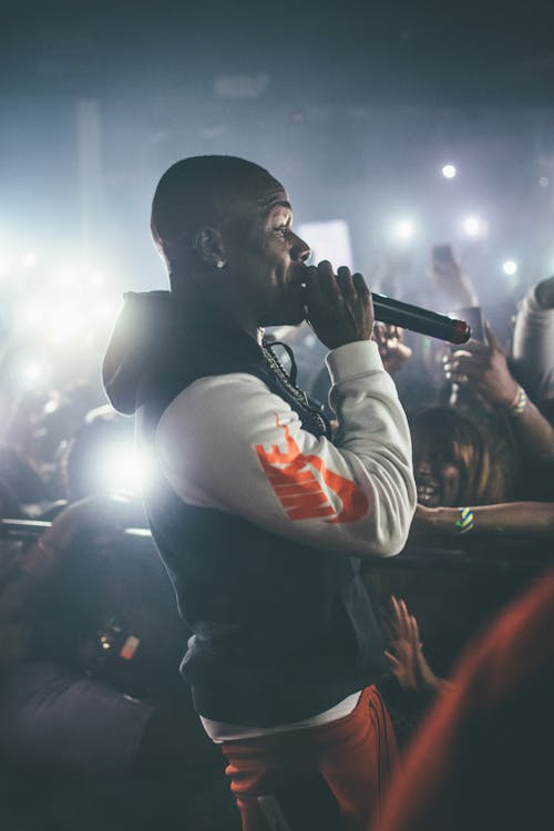 Man Wearing Hoodie While Performing in Front of Audience