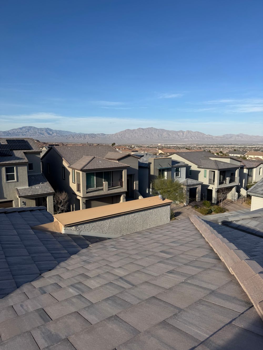 Tile roofed homes in a Las Vegas neighborhood under a clear desert sky