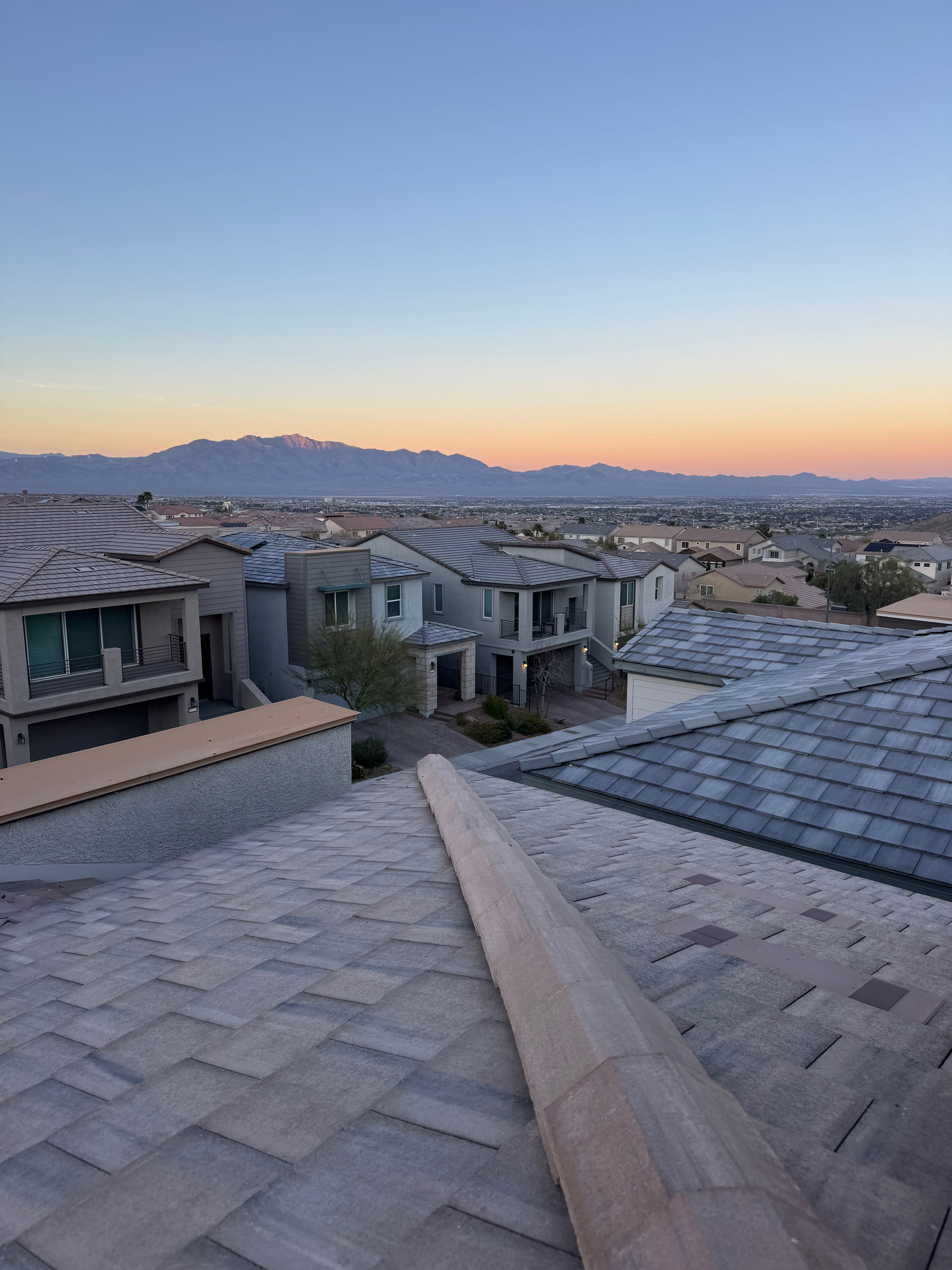 Las Vegas suburban rooftops at twilight with the mountains in the background, showing Clark County neighborhoods where most houses sold within 60 days