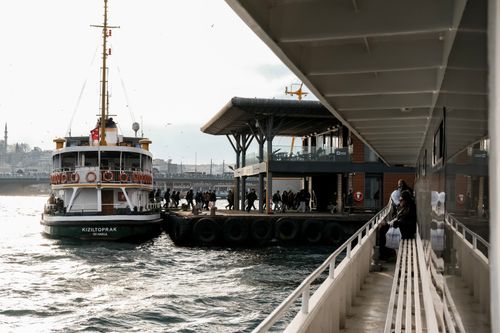 Free A bustling Istanbul ferry approaches Eminönü pier, capturing urban and maritime life. Stock Photo