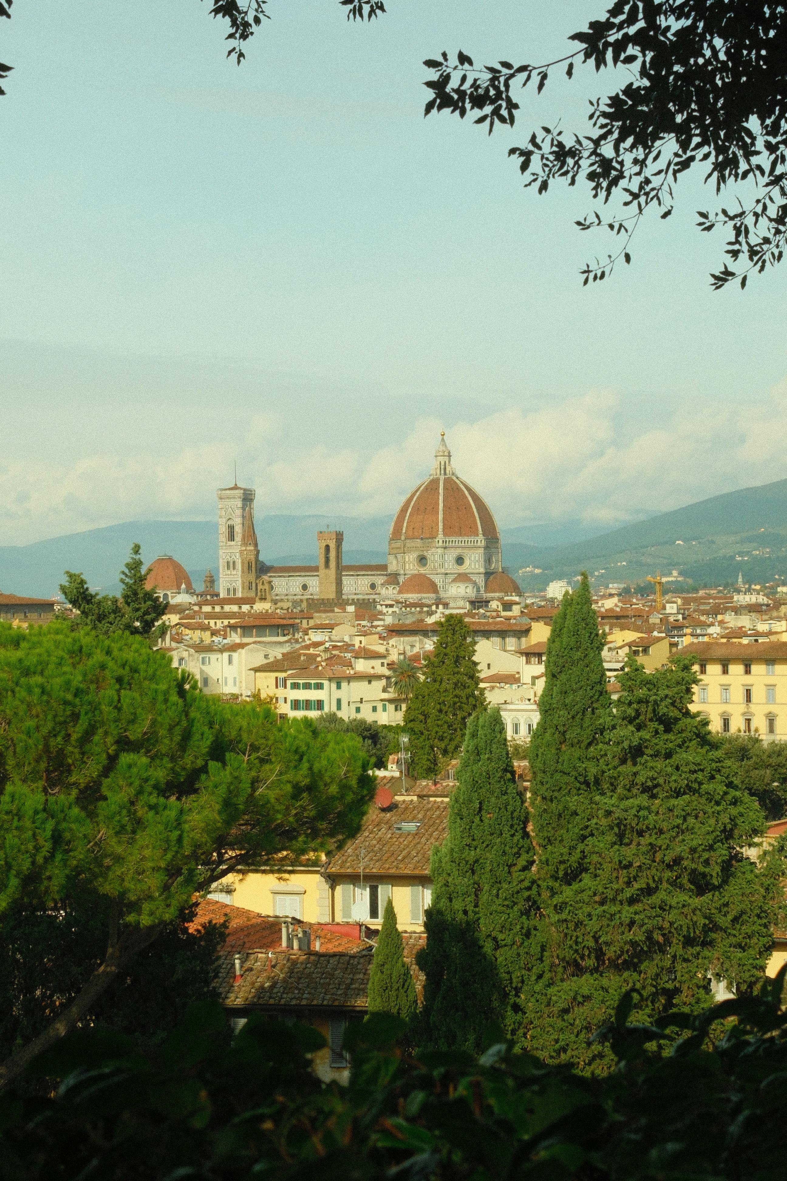 Panoramic view of Florence's iconic cathedral and skyline surrounded by lush greenery.