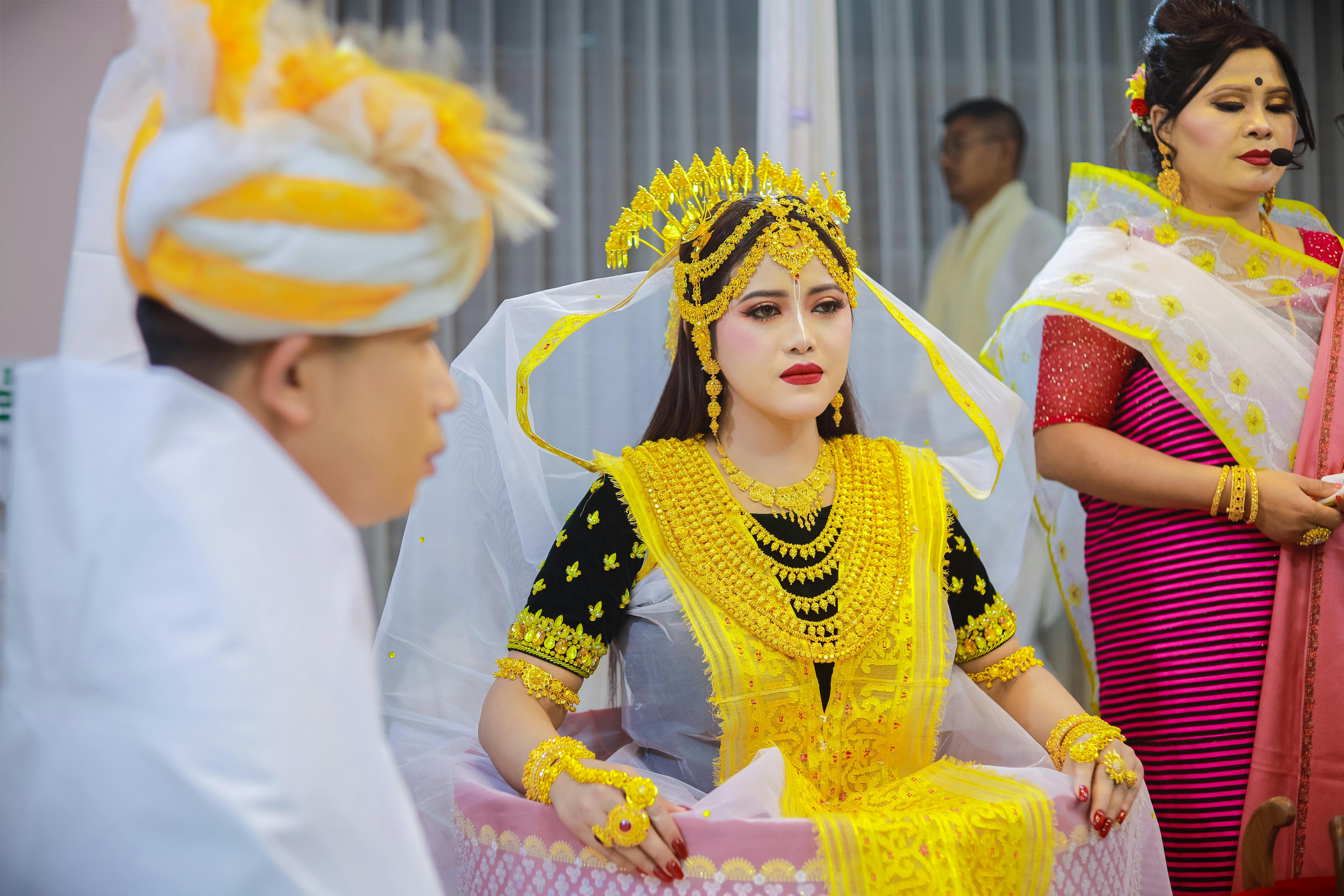 Elegant Indian wedding ceremony featuring traditional attire in vivid colors, captured indoors. A moment of cultural beauty.