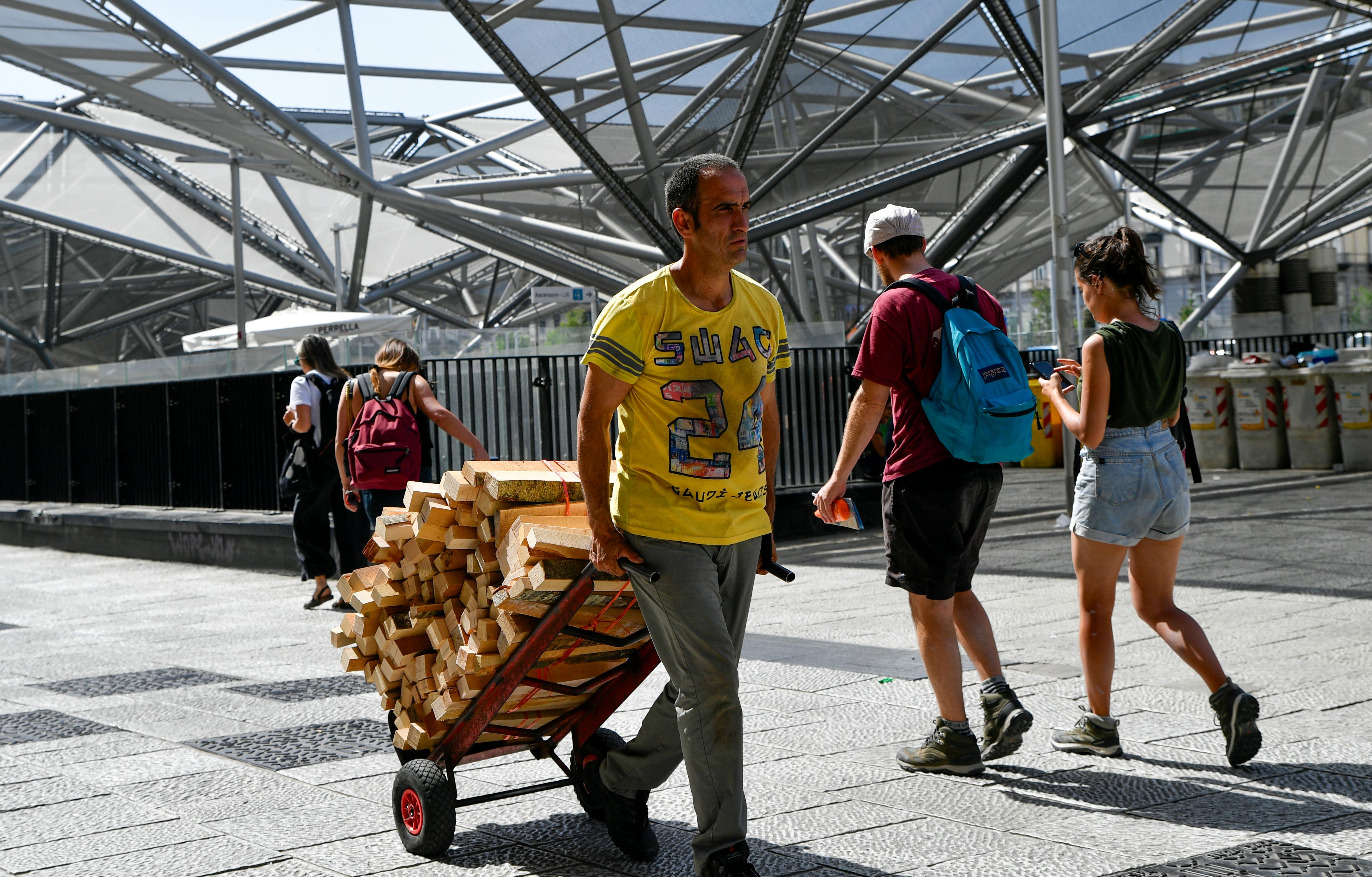 grátis Cena movimentada na Piazza Garibaldi, em Nápoles, com pedestres e um homem trabalhando. Foto profissional