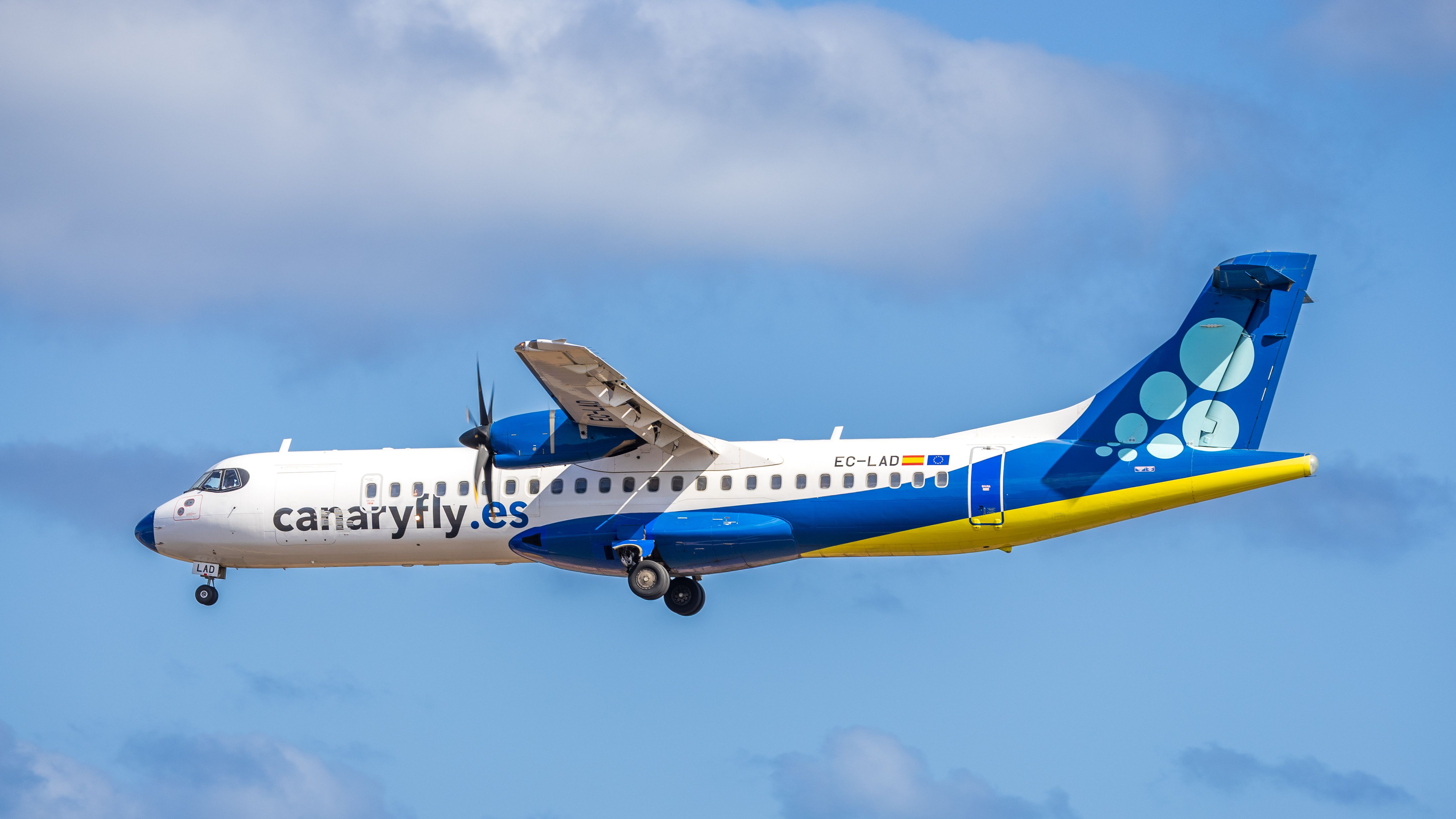 ATR 72 Passenger Plane in Flight with Clear Blue Sky · Free Stock Photo
