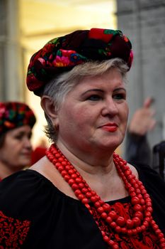 Woman in traditional Eastern European costume at a cultural event.