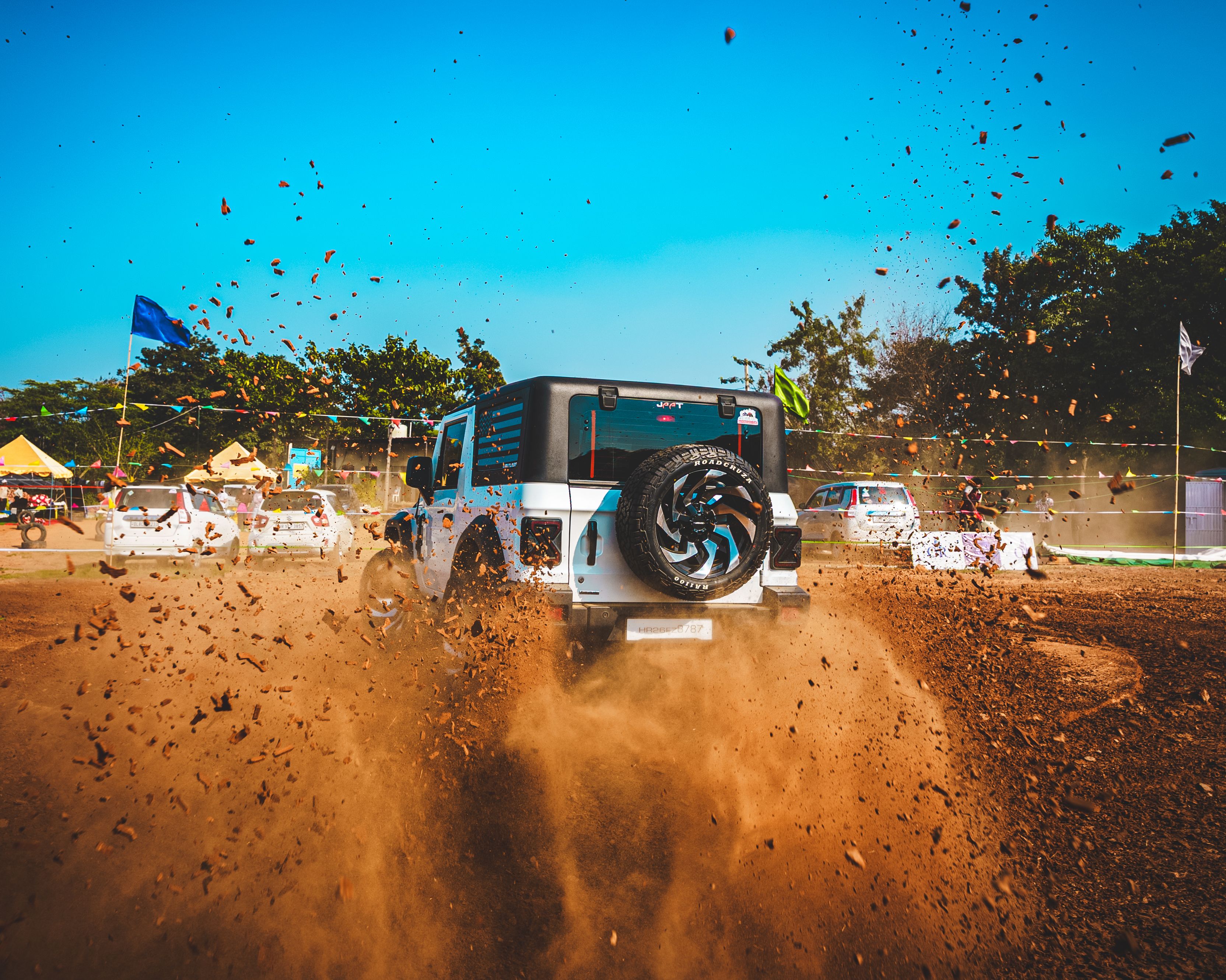 Explore powerful off-roading with a rugged SUV on a dusty trail, showcasing adventure and thrill.