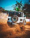 Rugged SUV Kicking Up Dirt in Off-Road Adventure