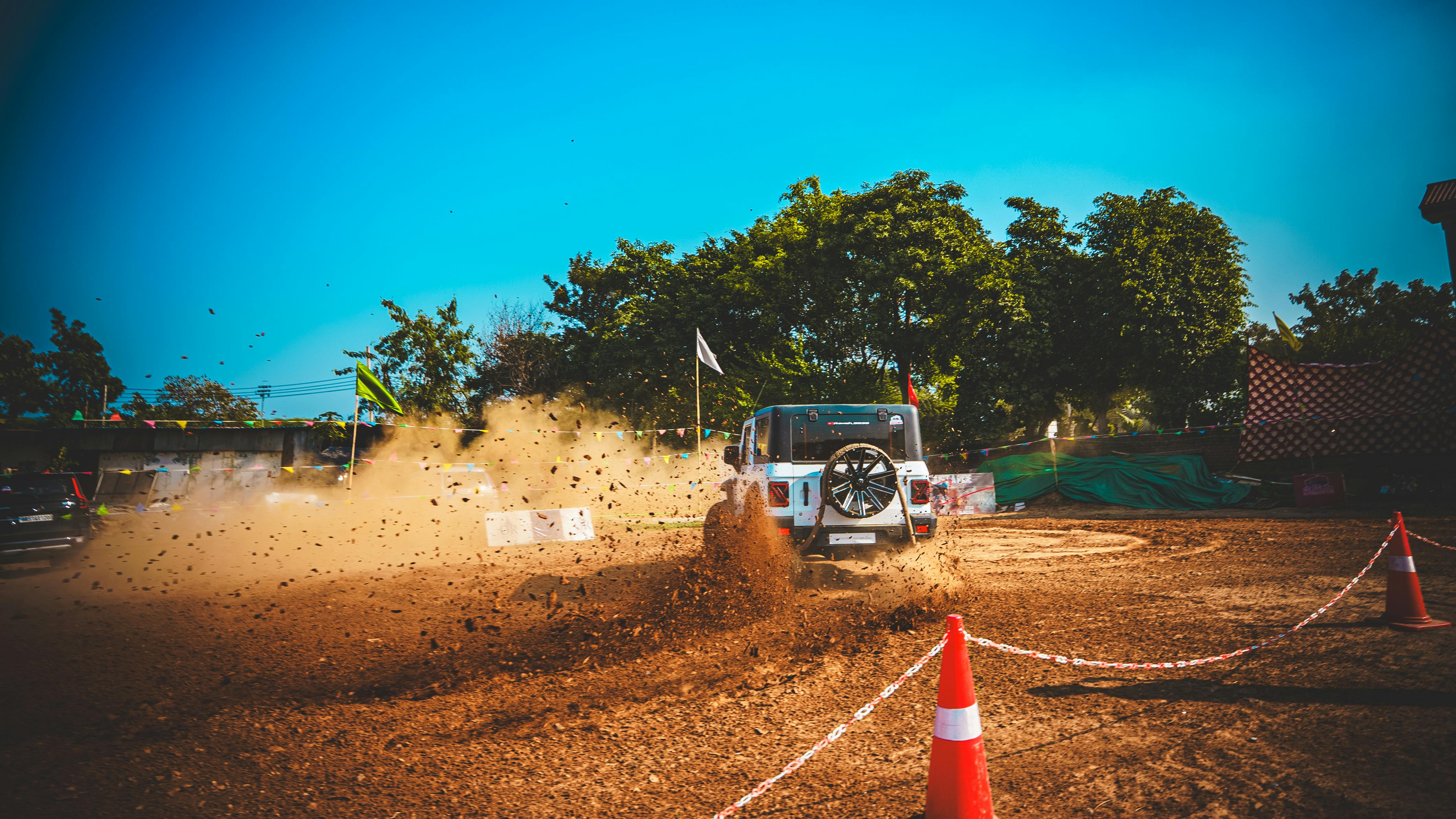 무료 강력한 SUV가 먼지투성이 지형을 질주하며 신나는 야외 모험 속에서 흙먼지를 일으키는 모습을 목격하세요. 스톡 사진