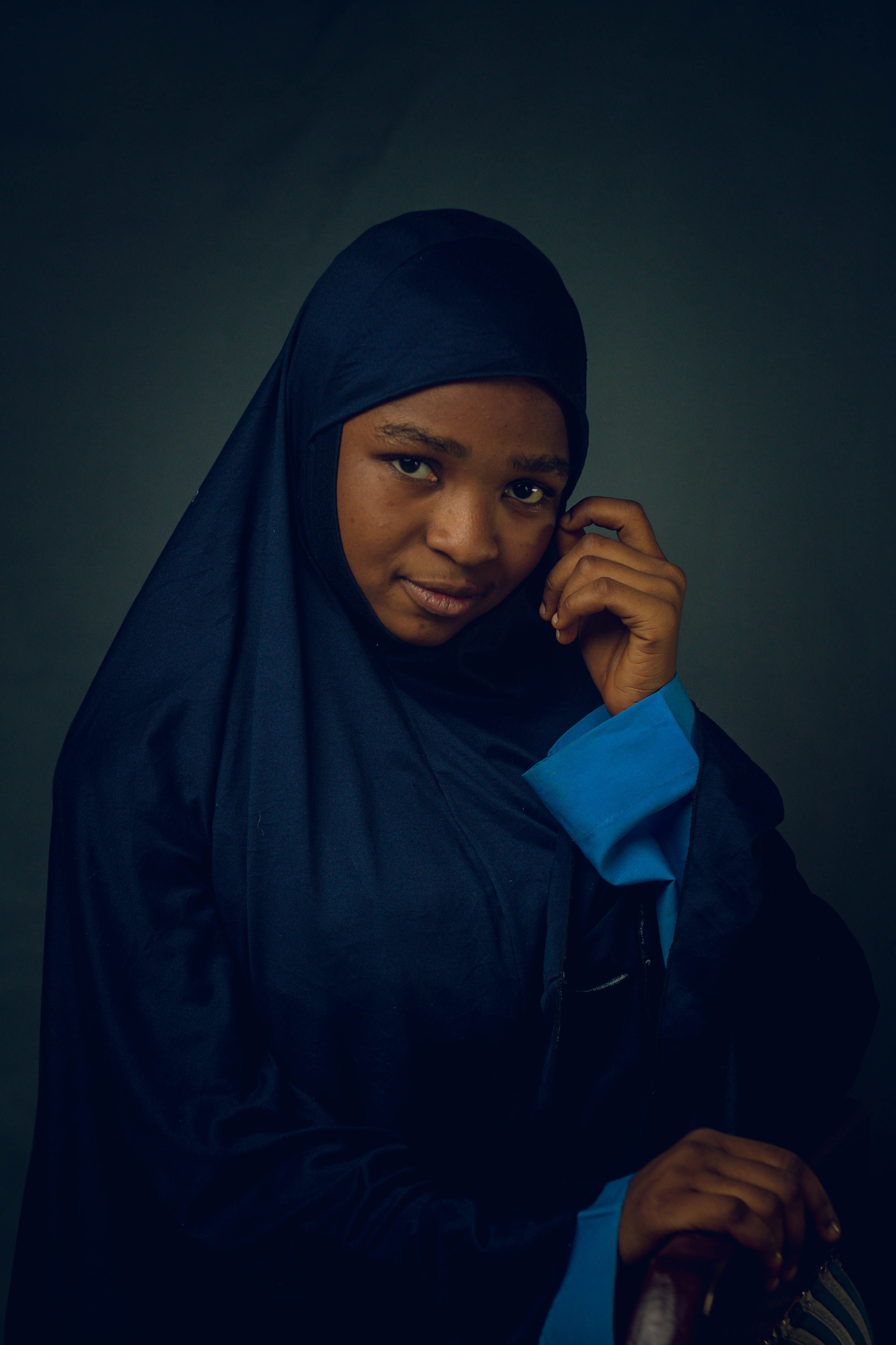 Portrait of a Woman in Dark Hijab and Blue Outfit · Free Stock Photo