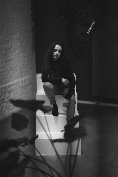 Free Artistic black and white portrait of a woman in an indoor studio setting. Stock Photo