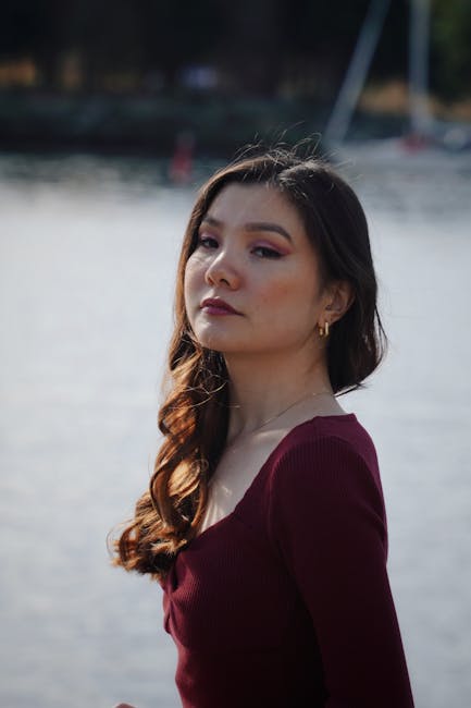 Elegant portrait of a woman with a scenic waterfront background in Vancouver.