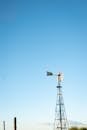 Rural Windmill Tower Against Blue Sky