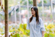 Woman in Floral Dress Enjoying Outdoor Garden