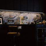 Dark bar counter with espresso machine — photo by Gatsby Yang on Pexels