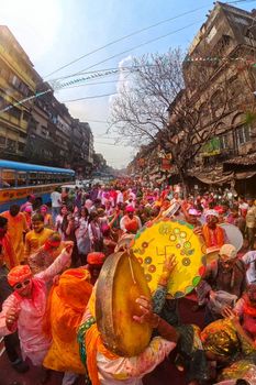 Colorful festival of Holi celebrated with joy and enthusiasm on lively streets of Kolkata, India.
