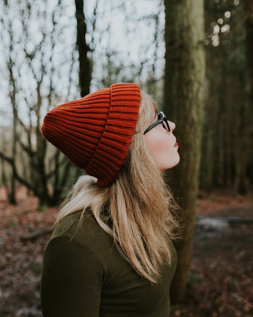 Woman in Red Knit Cap and Brown Sweater