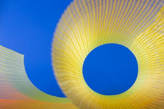 Dynamic abstract image featuring a vibrant yellow spiral against a bright blue background, creating a lively contrast. — photo by Valentin Ivantsov