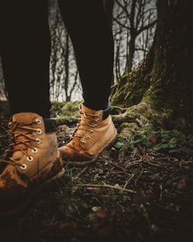 Close-up of hiking boots on a forest path during a nature walk.