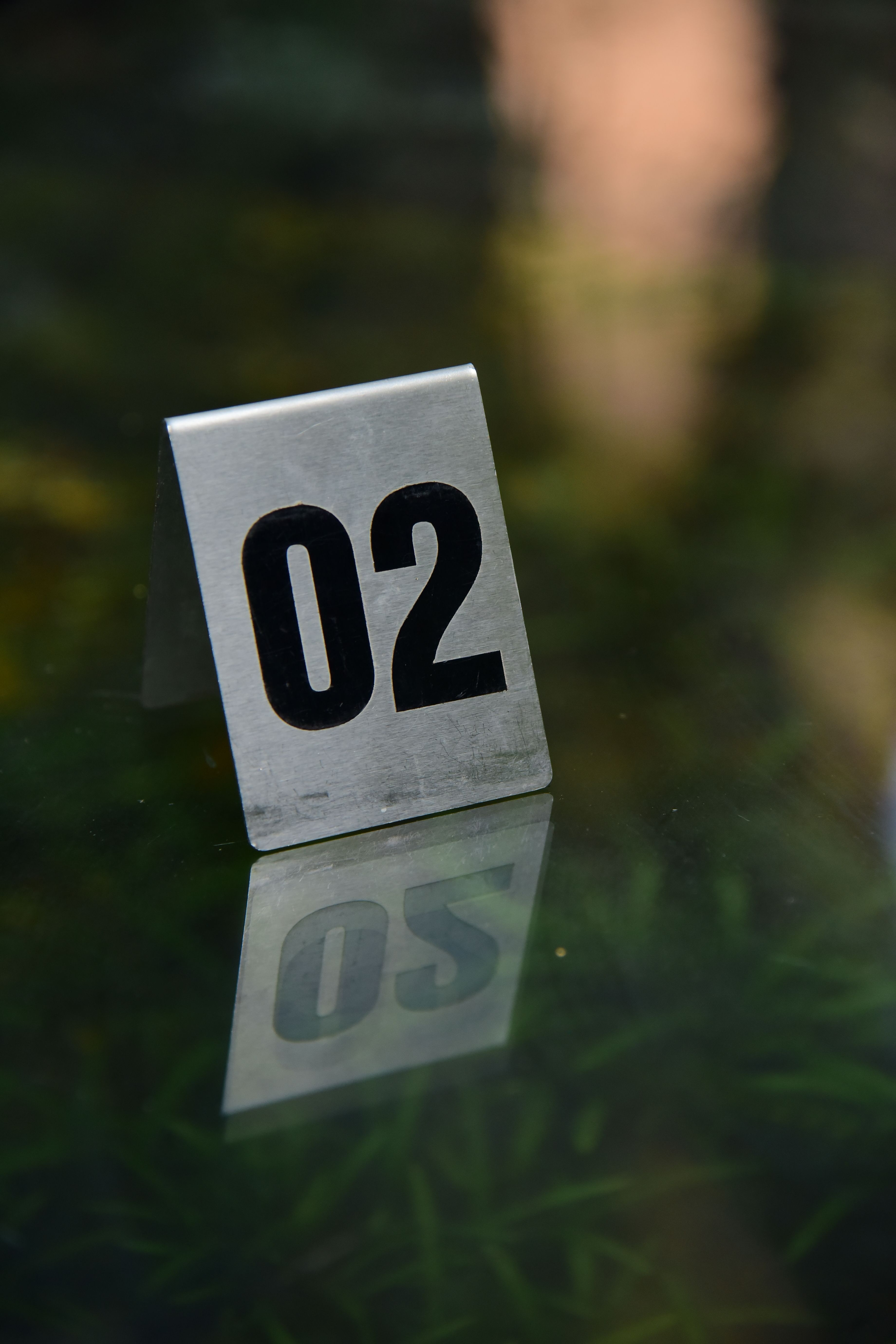 Metal Table Number 02 with Reflection · Free Stock Photo