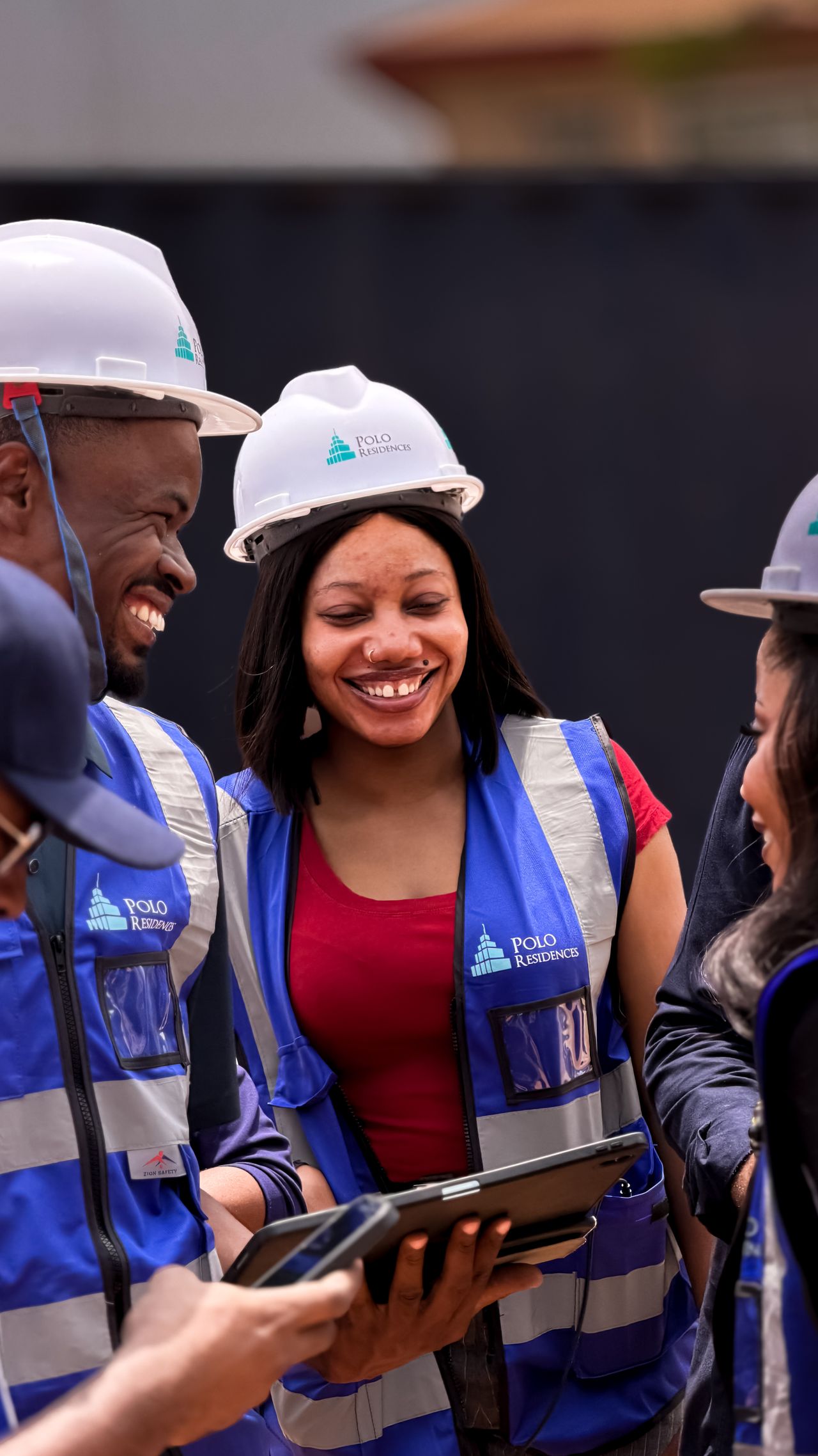 Smiling construction crew in hard hats at a new-home build site