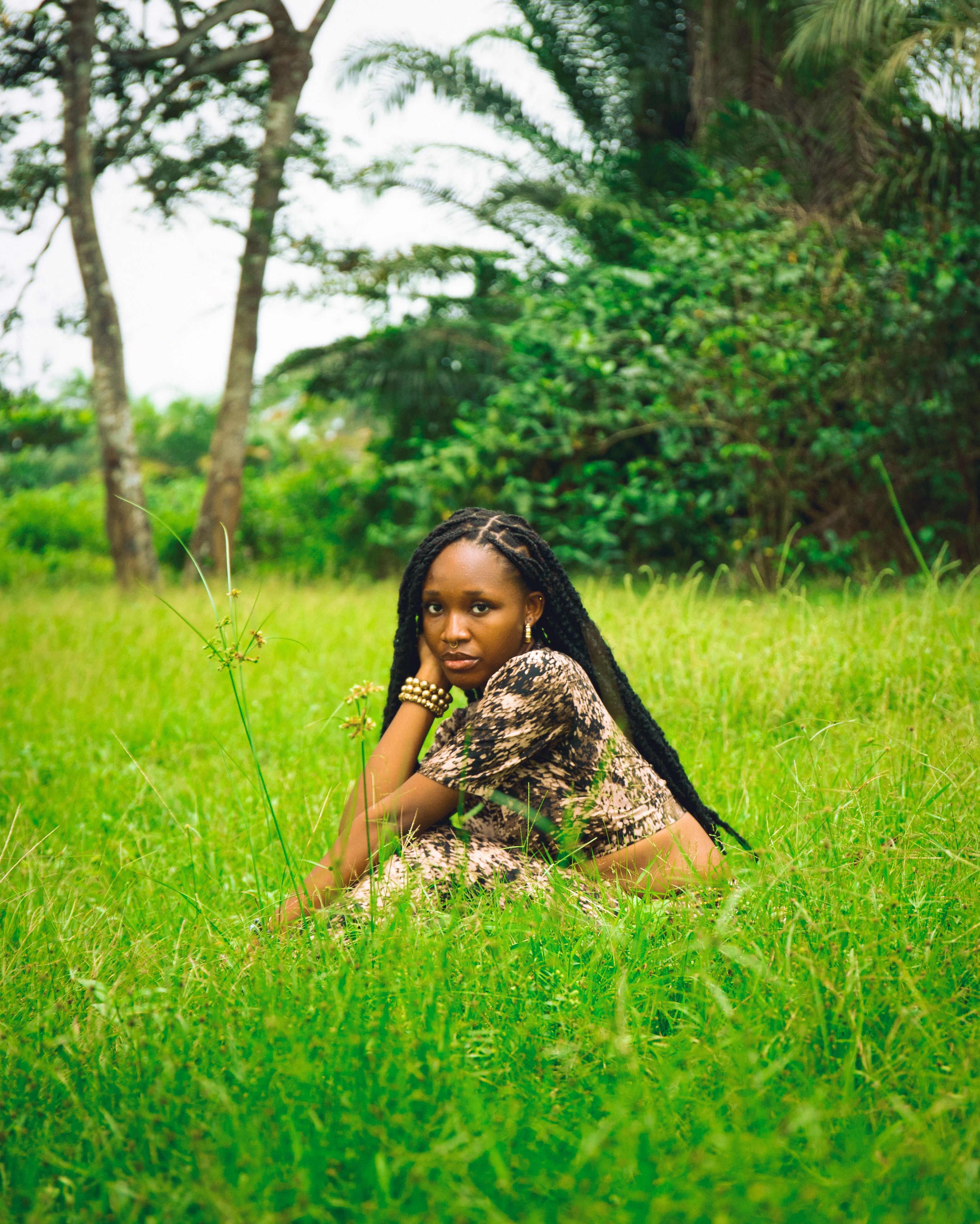 Young Woman Relaxing in a Lush Green Field · Free Stock Photo