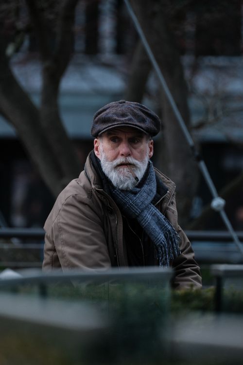 Free Thoughtful portrait of a mature man outdoors in winter clothing, conveying a contemplative mood. Stock Photo
