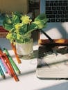Creative Work Desk with Flowers and Laptop