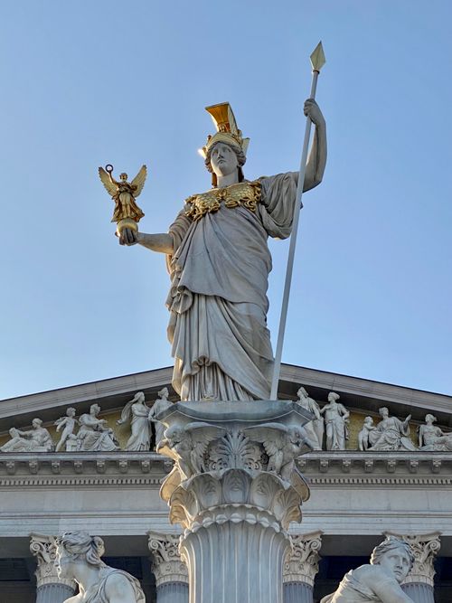 Free Majestic statue of Greek goddess Athena adorned with gold accents, in Vienna. Stock Photo