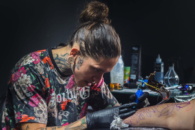 Tattoo artist focused on work