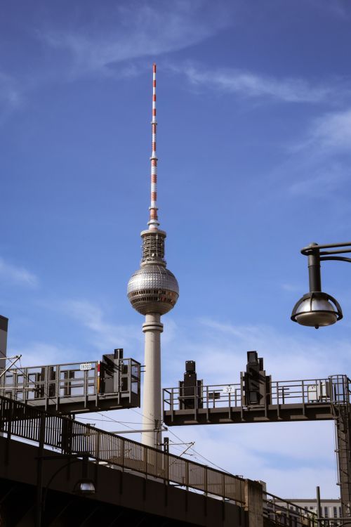 Free Iconic Berlin TV Tower with a clear sky backdrop, featuring urban infrastructure. Stock Photo
