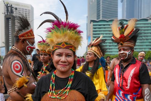Free Vibrant participants in traditional attire during a cultural parade in Jakarta, Indonesia. Stock Photo