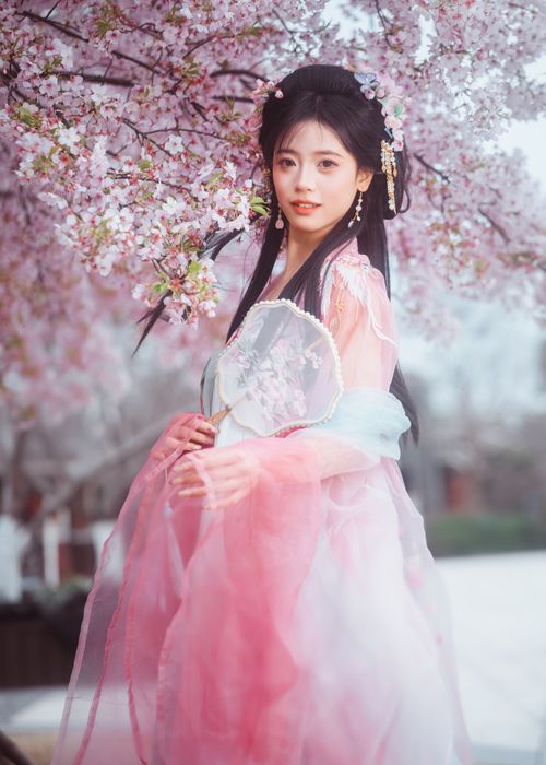 Free Beautiful woman in pink traditional dress with cherry blossoms in spring. Stock Photo