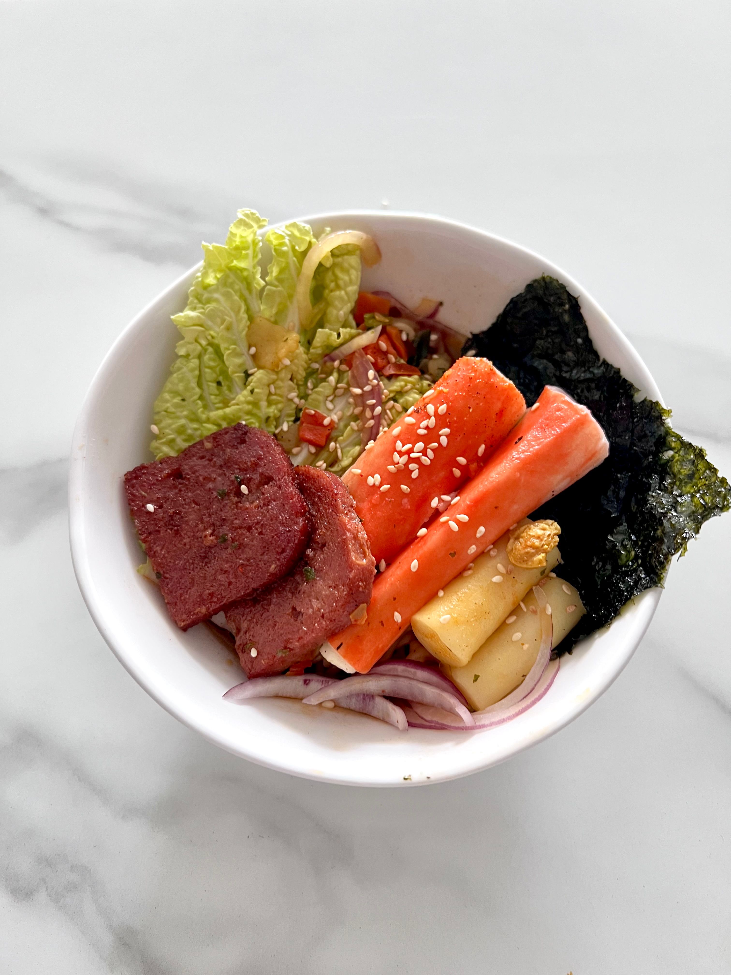 Vibrant poke bowl with crab sticks, seaweed, and fresh veggies, perfect for Asian cuisine lovers.