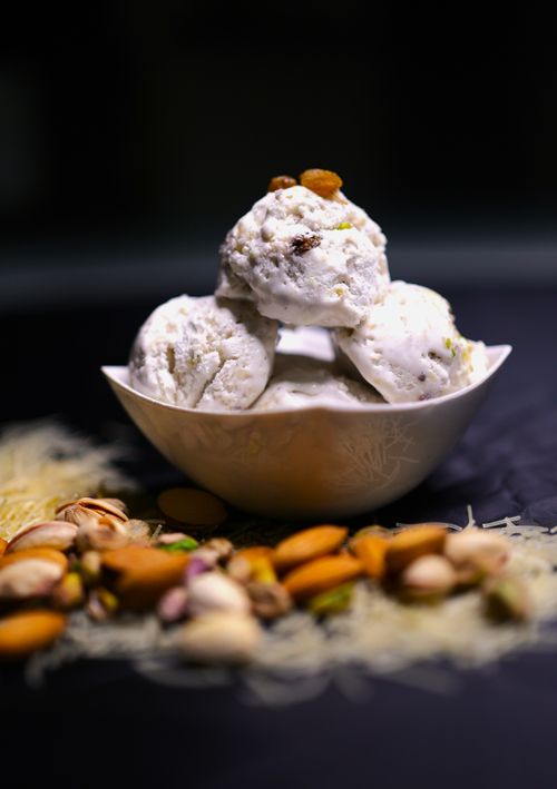 Free Creamy kulfi ice cream topped with assorted nuts, perfect for a sweet treat. Stock Photo