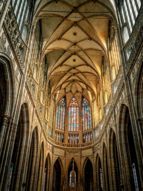 Free Majestic interior view of a Gothic-style cathedral with intricate arches and stained glass windows. Stock Photo