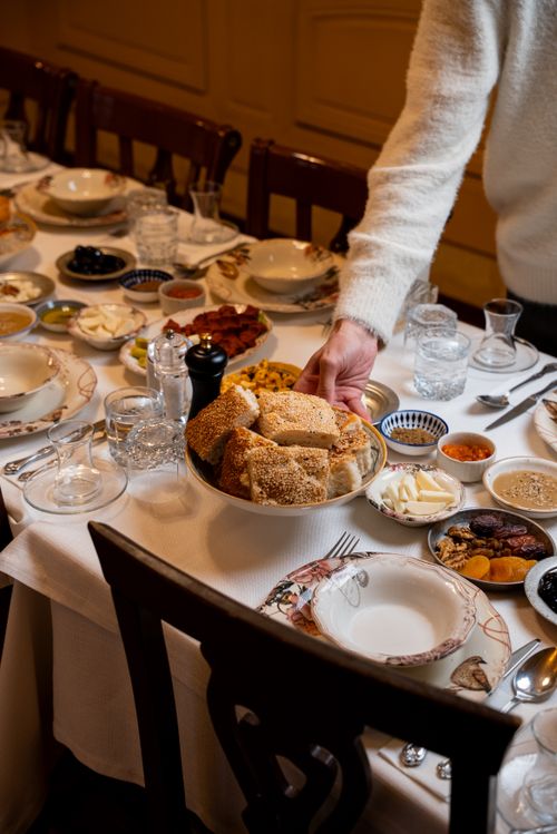 Free A traditional Turkish breakfast spread with bread, olives, and dried fruits on a beautifully set table. Stock Photo