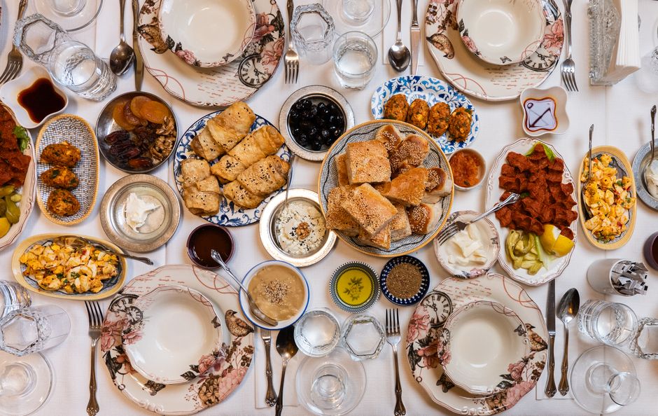 A top-down view of a traditional Turkish feast with assorted dishes and elegant tableware.