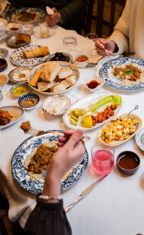 Free A cozy gathering around a table filled with traditional Turkish dishes in Gaziantep, Türkiye. Stock Photo