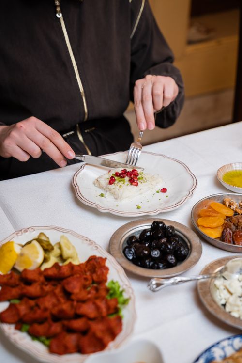 Free An elegant table setup featuring a variety of Turkish mezze dishes alongside rice garnished with pomegranate. Stock Photo