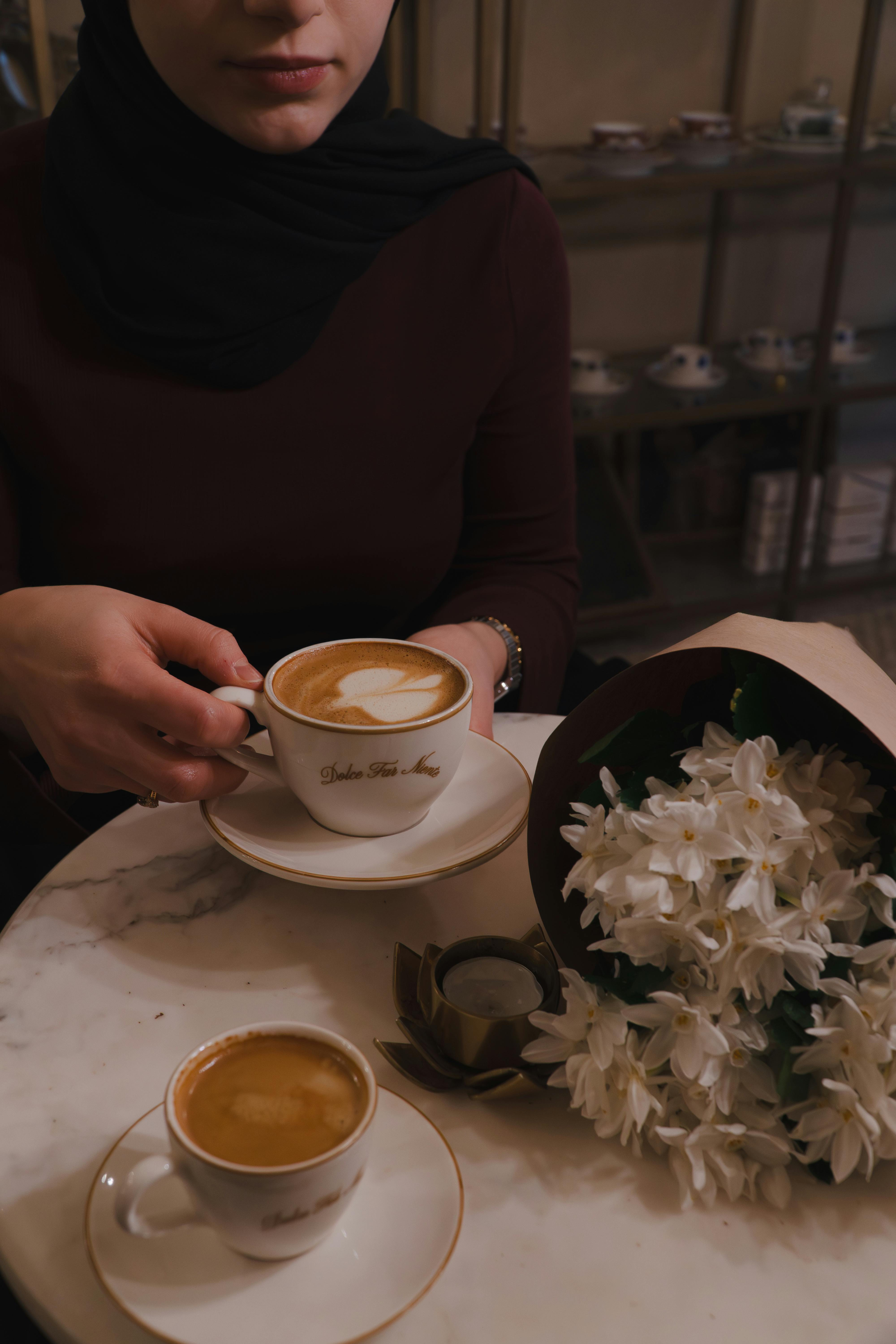 Bezpłatne Spokojna chwila w kawiarni w Stambule, z latte, espresso i białymi kwiatami na marmurowym stoliku. Zdjęcie z galerii